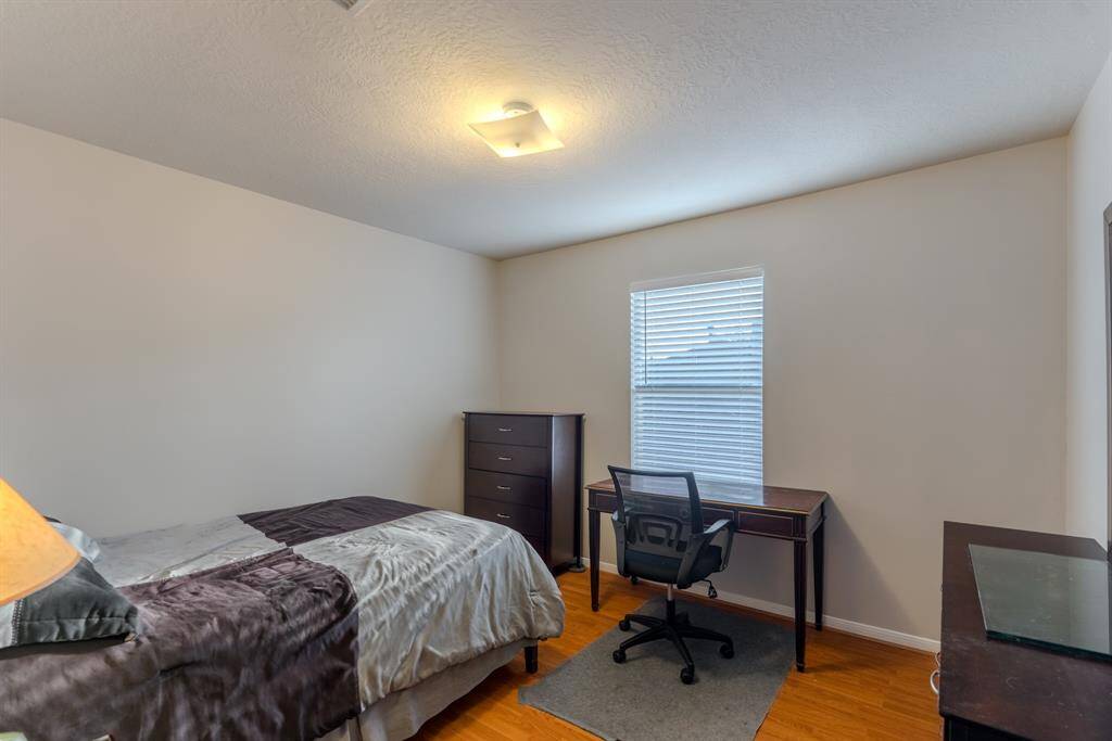 secondary bedroom is spacious, filled with natural light, and offers plenty of closet space