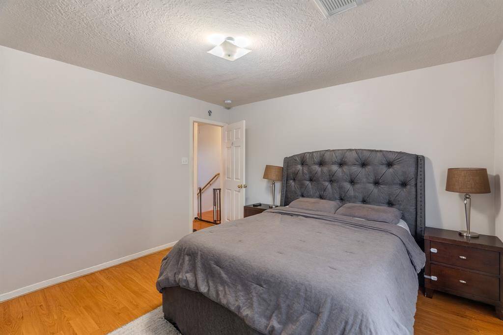 The second upstairs bedroom is generously sized, filled with natural light, and offers a spacious closet