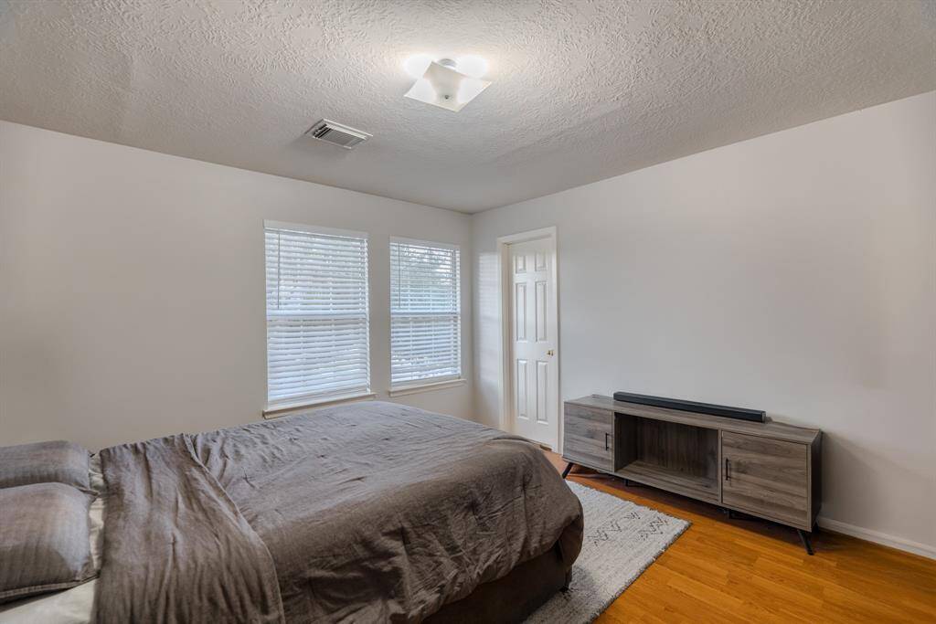 The second upstairs bedroom is generously sized, filled with natural light, and offers a spacious closet