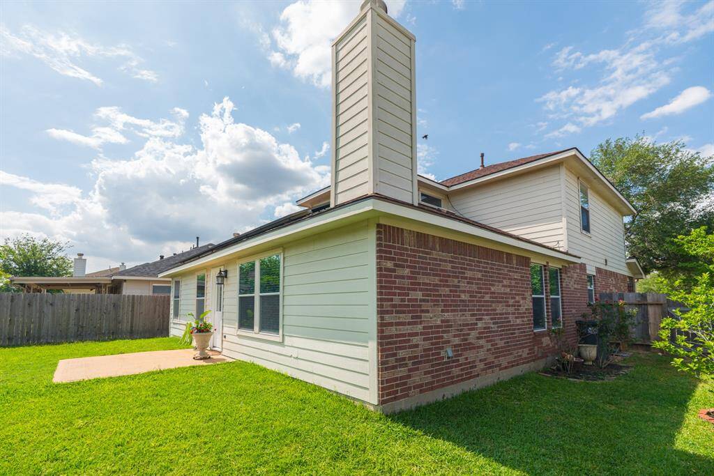 The spacious backyard on this corner lot provides ample room for outdoor entertaining, gardening, or play