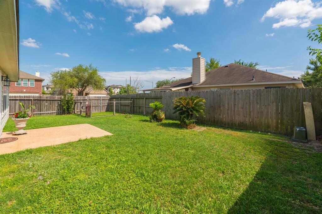 The spacious backyard on this corner lot provides ample room for outdoor entertaining, gardening, or play