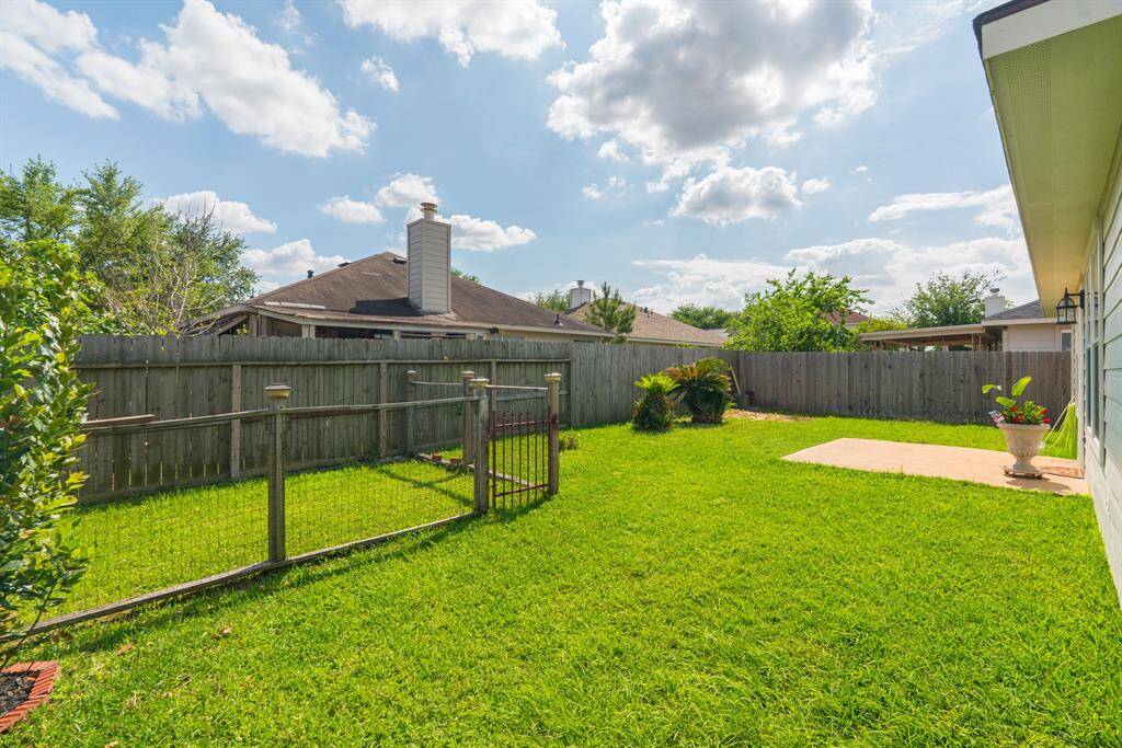 The spacious backyard on this corner lot provides ample room for outdoor entertaining, gardening, or play