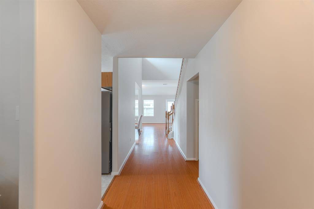 A welcoming hallway greets you at the entrance, with a bright formal dining area to your left filled with natural light