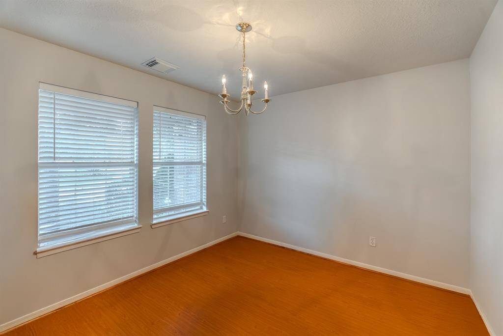 A welcoming hallway greets you at the entrance, with a bright formal dining area to your left filled with natural light