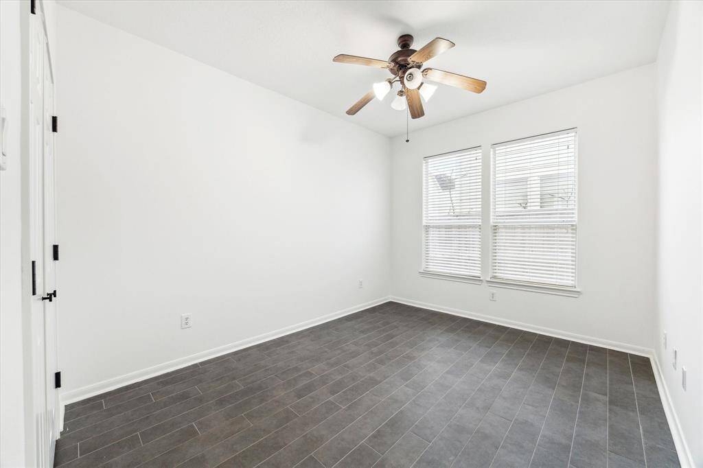 This versatile downstairs bedroom offers an ideal space for a home office, featuring a private location within the home along with convenient access to a nearby bathroom and flex room.