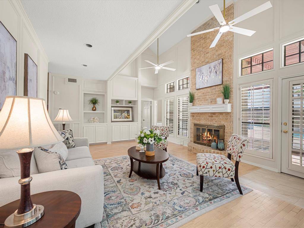 Spacious family room anchored by a cozy fireplace, perfect for relaxing or entertaining