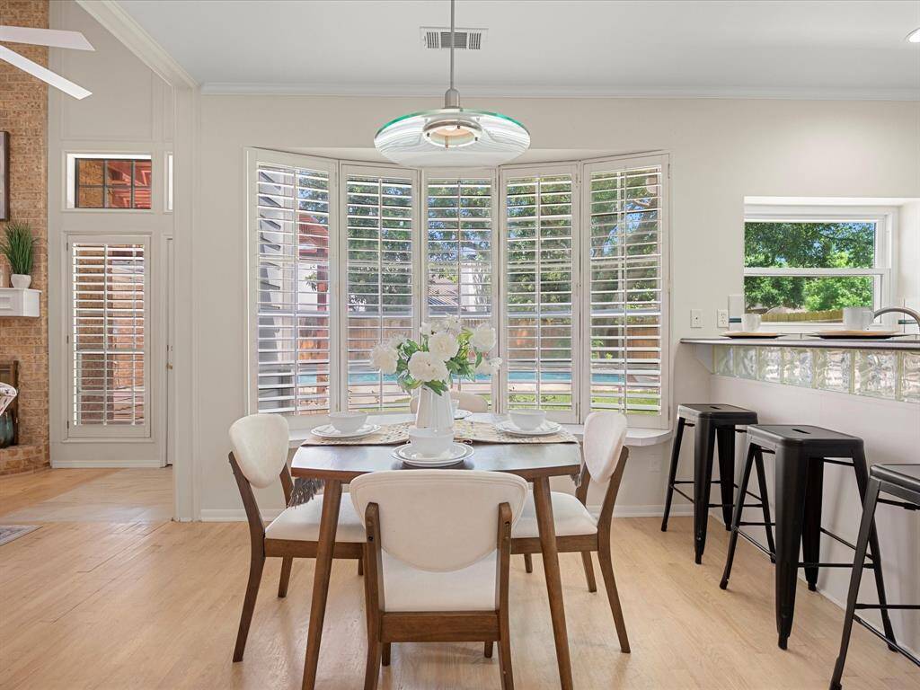 Charming breakfast area nestled between the kitchen and family room, featuring bay windows that offer a picturesque view of the sparkling backyard pool.