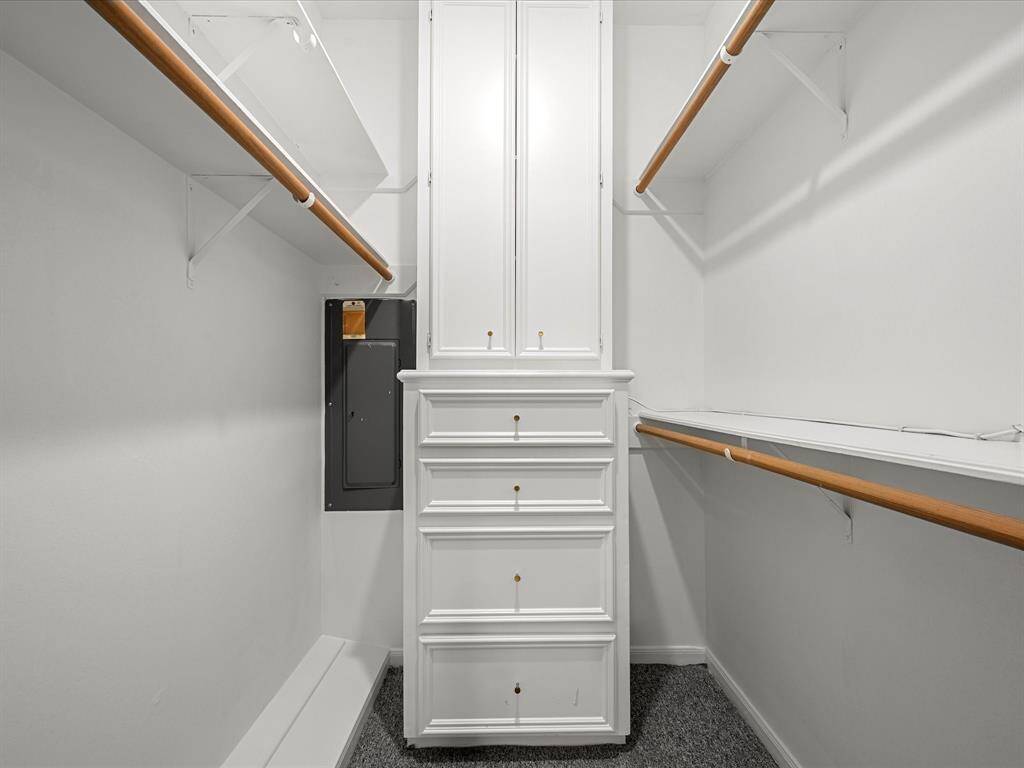 Primary closet features plenty of clothes hanging space.