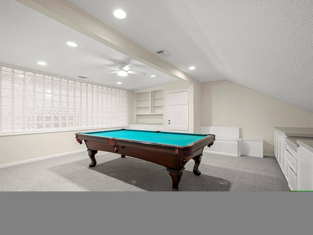 Be impressed by the expansive second-floor game room—perfect for entertaining or relaxing