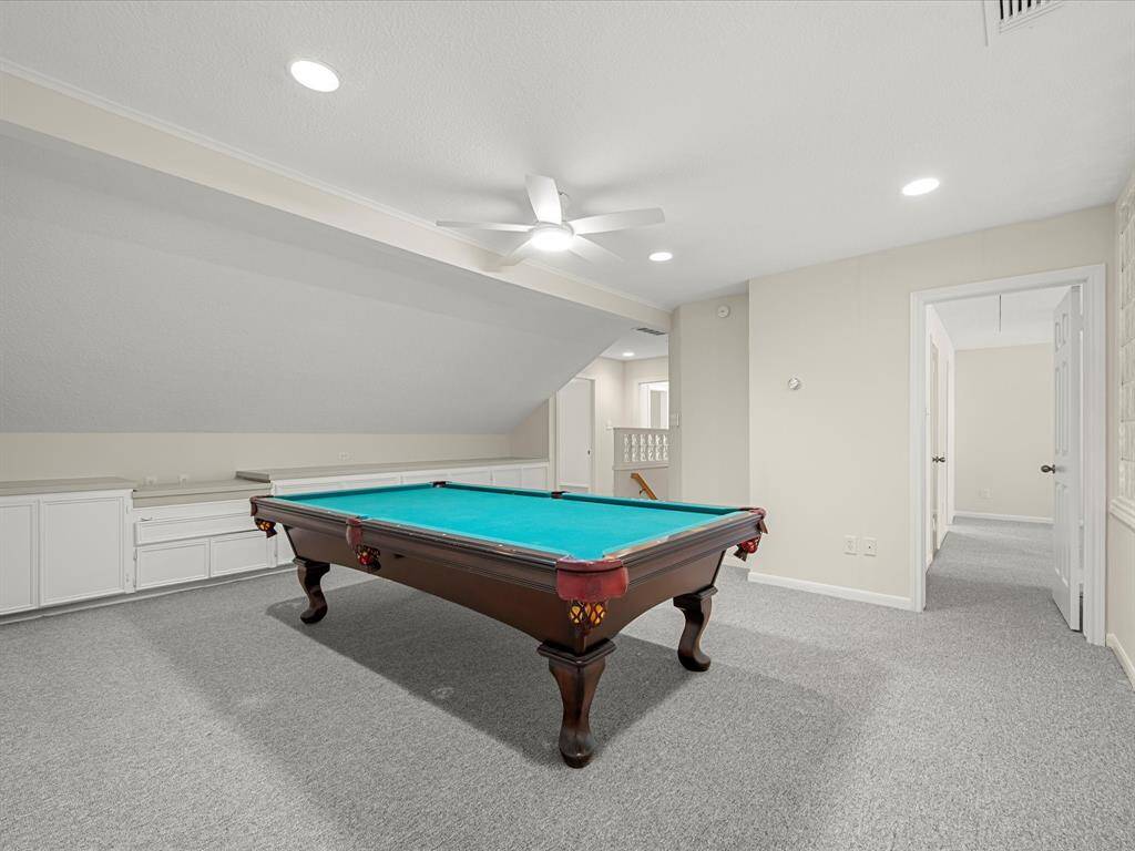 A truly impressive upstairs game room provides the perfect retreat for recreation or gatherings