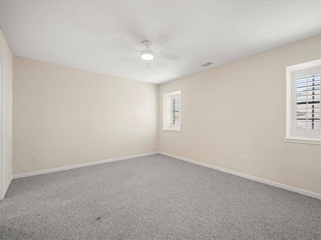 Spacious fourth bedroom with a walk-in closet and a private vanity that connects to a shared full bath—offering both comfort and convenience.