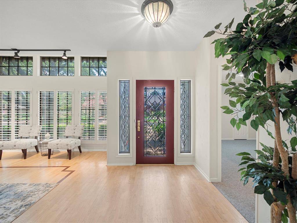Stately entry door with dual side windows that brighten the foyer