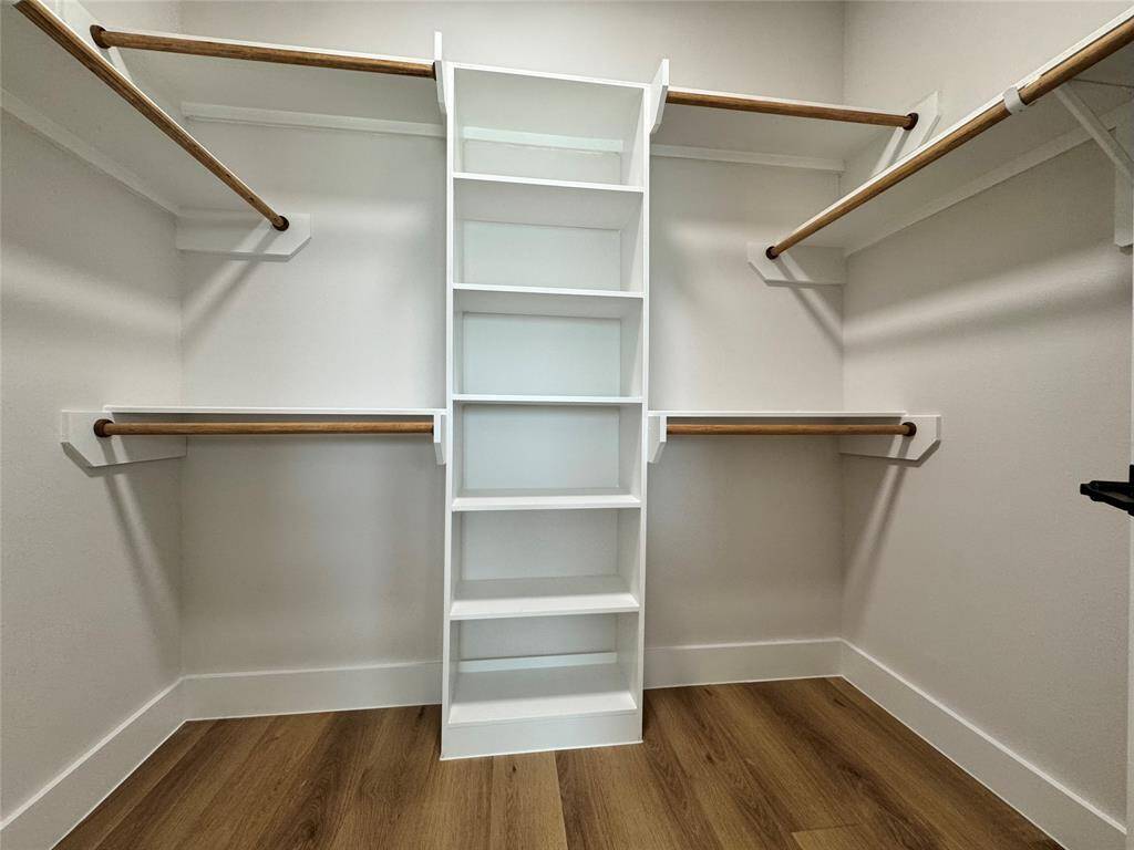 Walk in closet, 1 of 2 in the primary with built ins.