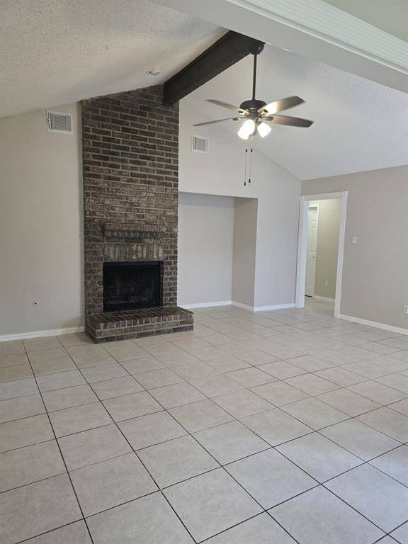 Ceilings with a central  fan,  tile flooring, and ample natural light from large windows. The open layout connects to the dining and kitchen areas, enhancing the home's airy feel
