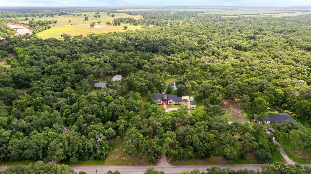 Wide-angle view of open yard showcasing the property’s generous flat terrain and park-like setting.