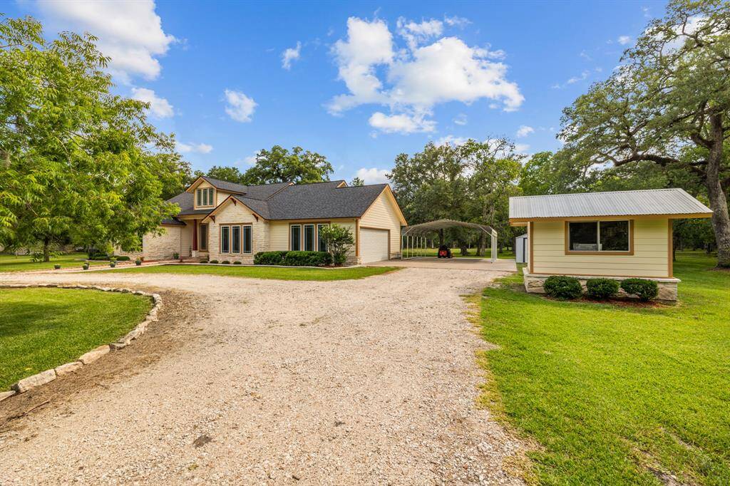 Elegant balance of living quarters and practical outbuildings: two-car oversized attached garage, storage shed, 2+ car carport for covered parking, and a custom built wellhouse to match the Home.