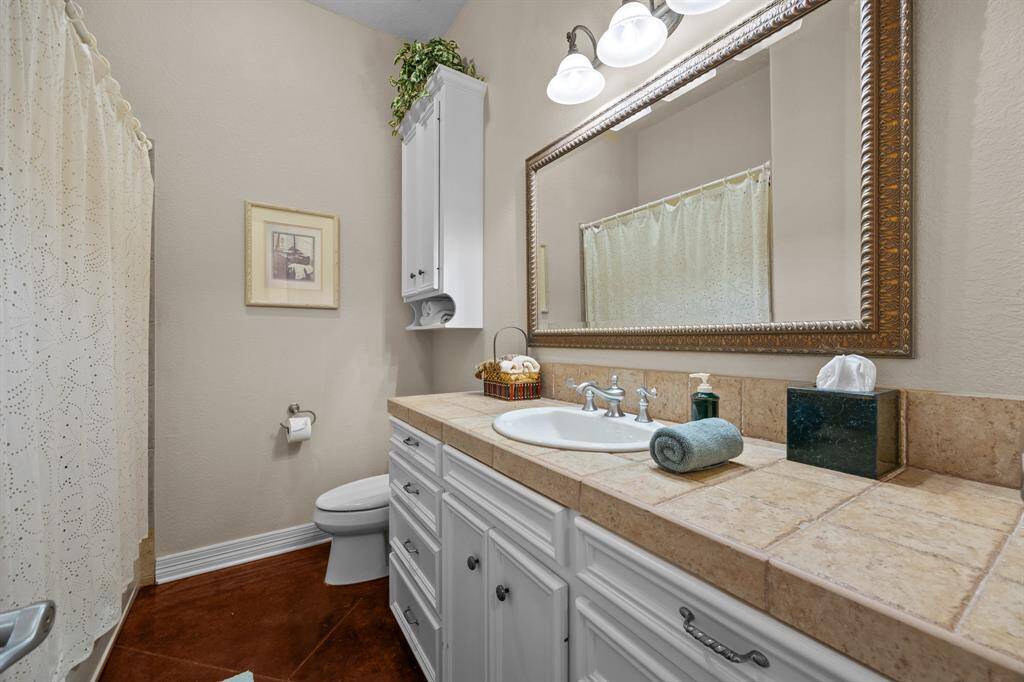 Tile-topped vanity with inset sink, large vanity maximizes style and function.