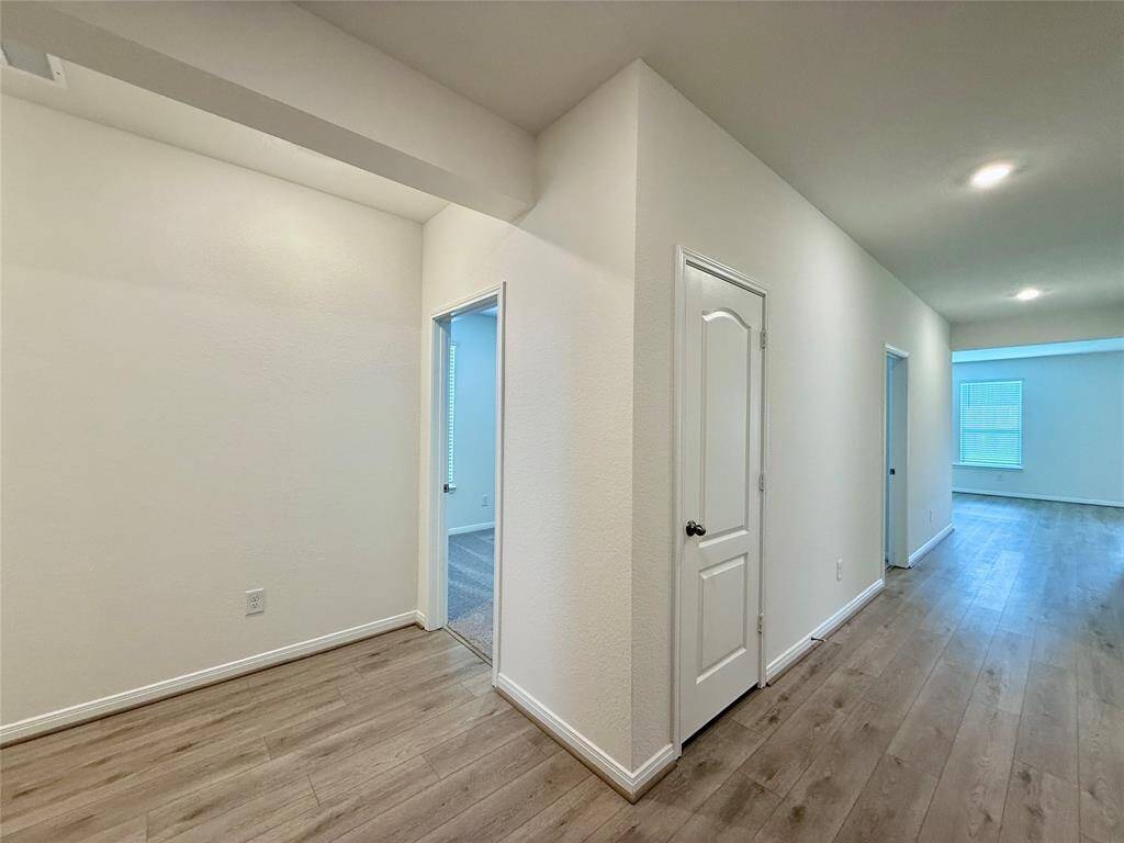 Just off the foyer, you'll find the secondary bedrooms and a full bath—perfect for guests or family.
