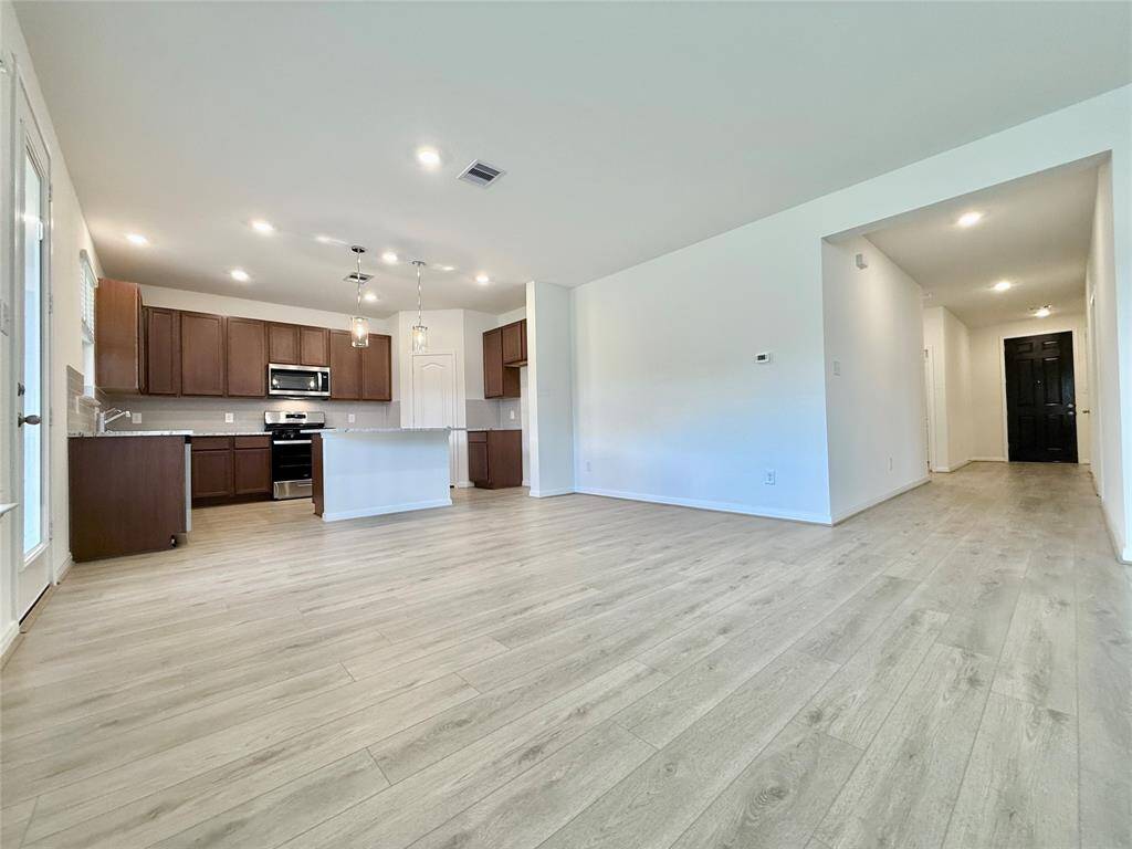 Open layout connects the family room, dining area, and spacious kitchen—perfect for gathering and entertaining.
