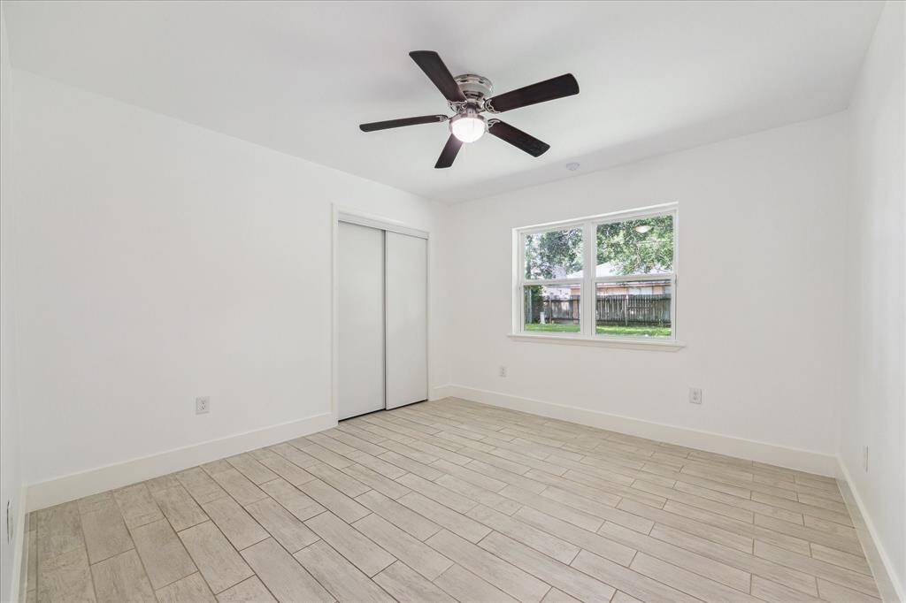 One of two secondary bedrooms. Window looks to back yard.