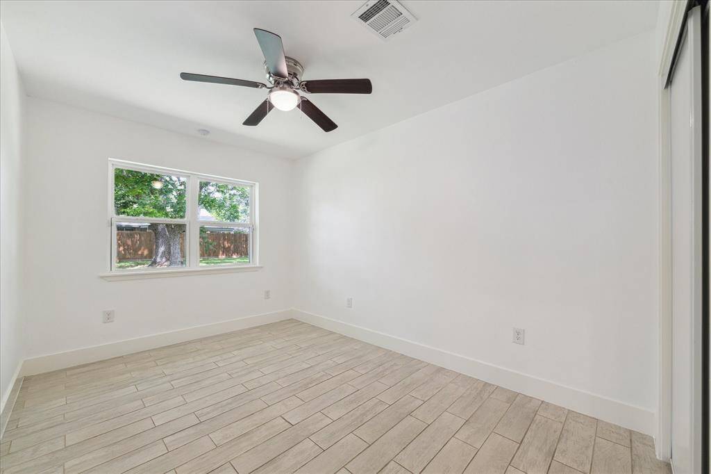 The additional secondary bedroom has double windows looking to backyard.