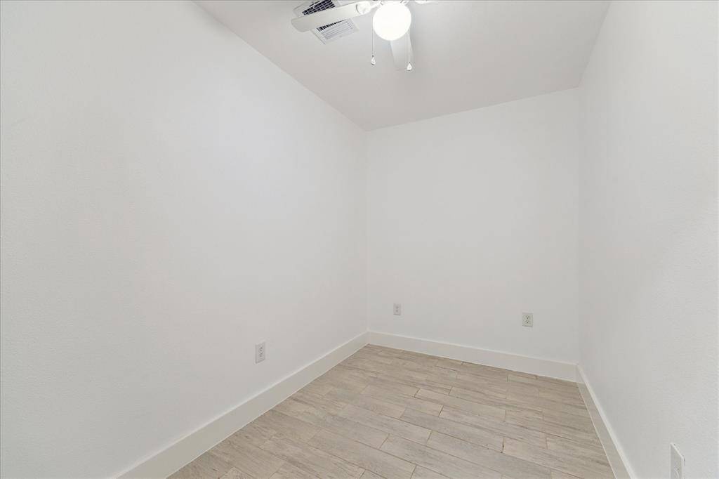 Located just behind the kitchen is this great bonus room that could be used as an office, study room or large storage area.