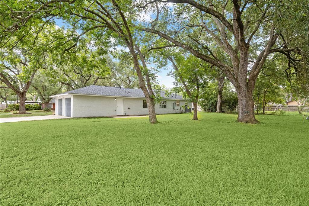 The massive 12,000 square foot lot can easily be seen from the back yard.   The entire corner lot is covered with beautiful trees.