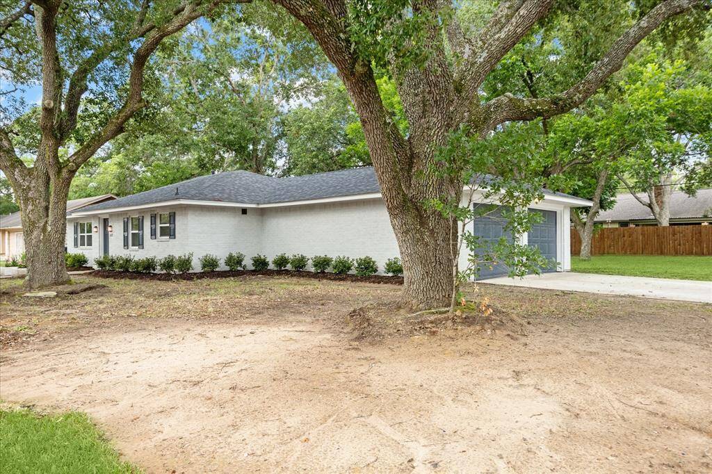 Large oak trees add to the charm of this home. The attached two car garage entrance is on the side street. Ample parking on driveway.