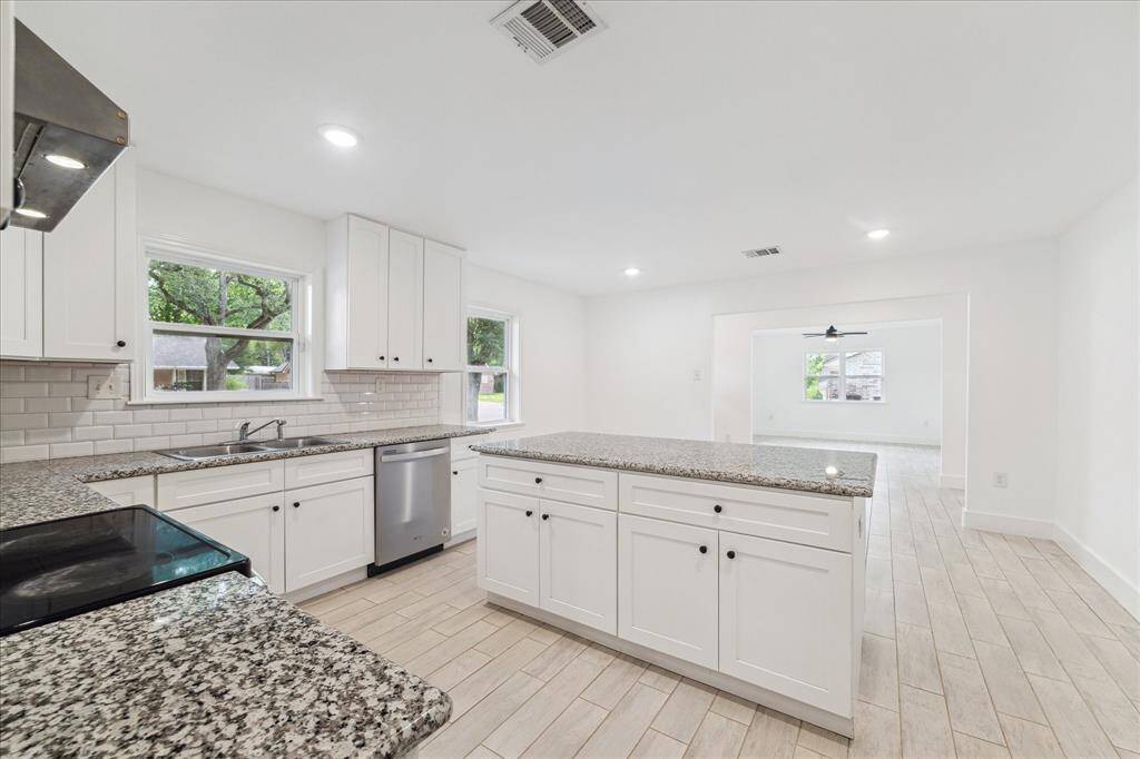 Large kitchen with island is open to the dining room.  Recessed lighting and new windows keep this home very light and bright.