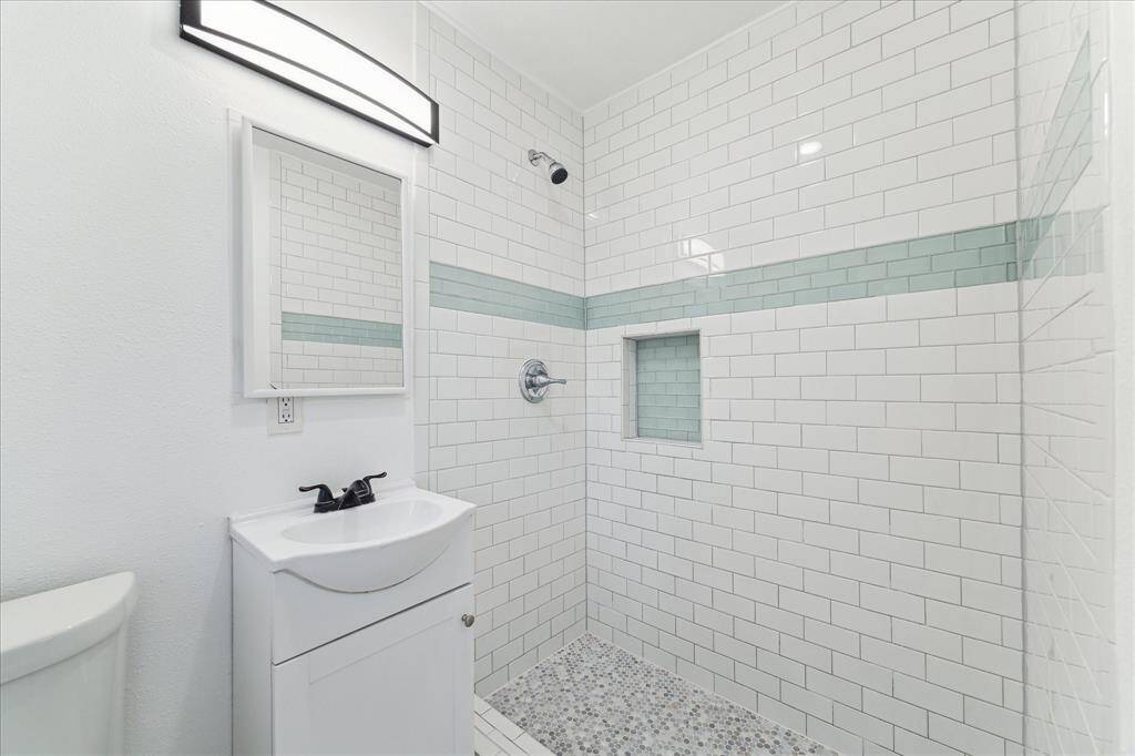 All new primary bath with with large subway tiled shower.