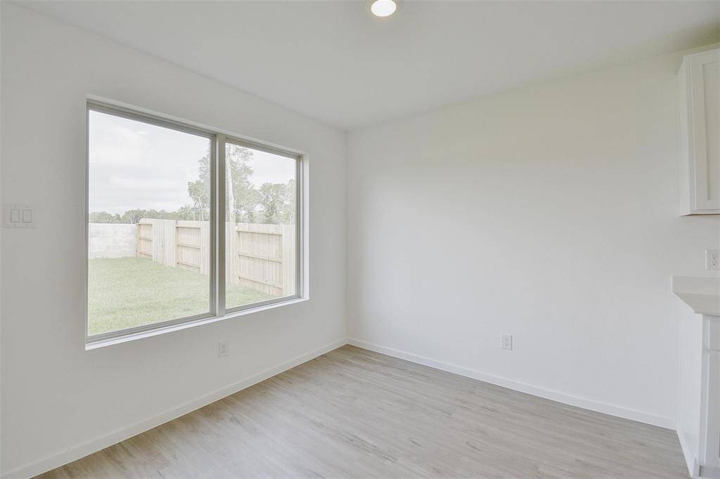 dining area adjacent to kitchen with plenty of room for a nice table view of the large backyard
