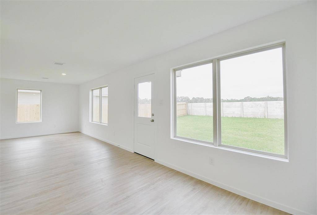 standing from the dining area looking at the back wall of family room