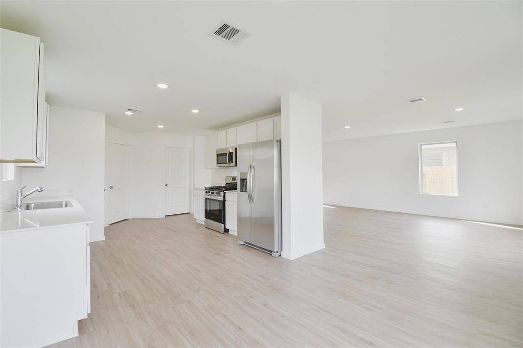 view from dining area into kitchen that is separate from family room view