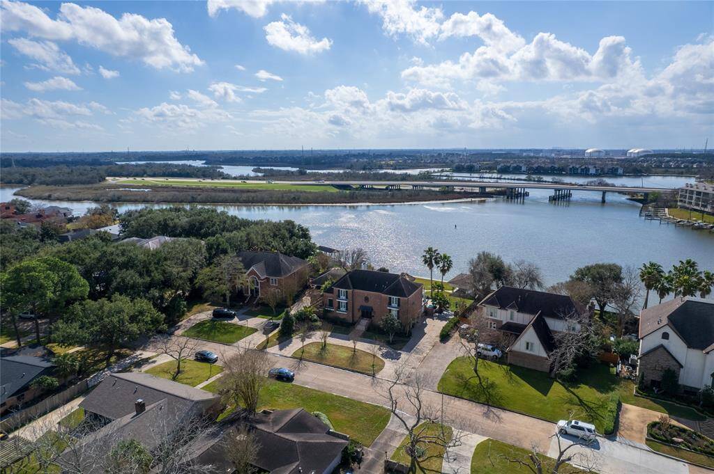 This photo showcases the serene Nassau Bay neighborhood with the spacious home situated along clear creek which takes you all the way out to Galveston Bay