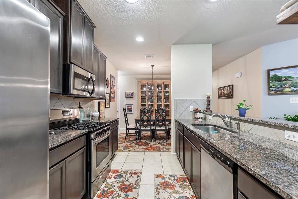 View from Kitchen to Dining Room with Breakfast Bar to the Right