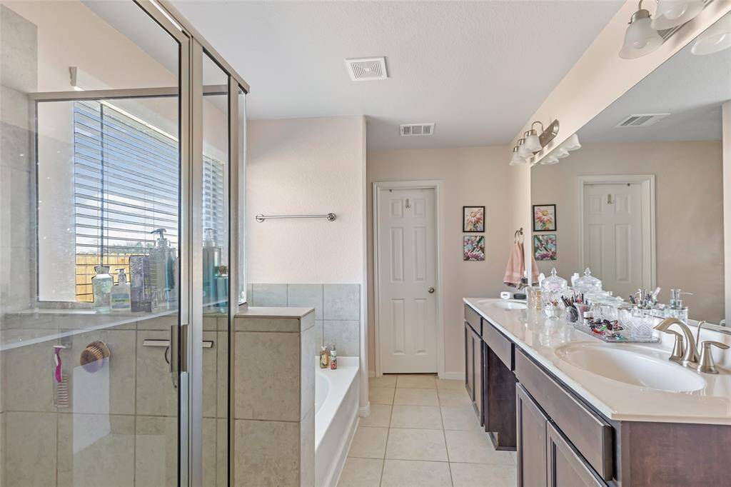 En Suite Primary Bath features double sinks and separate shower and soaking tub