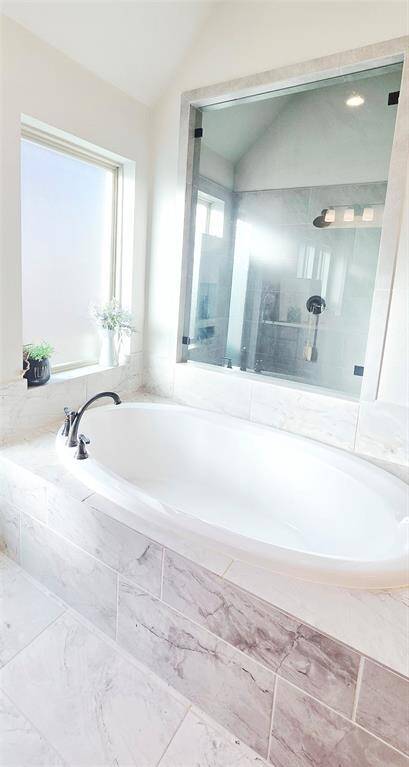 Primary bathroom with shower overlooking garden tub