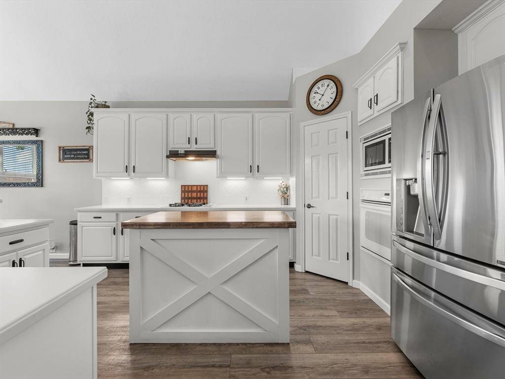 The updated kitchen has butcher block island