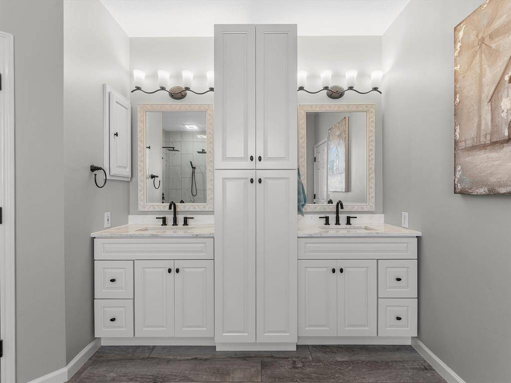 The updated cabinets along with hardware and lighting/plumbing fixtures are modern and sleek