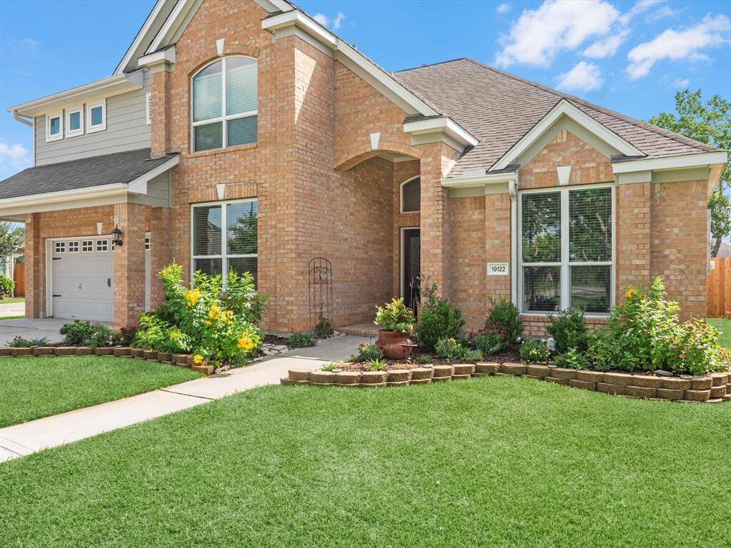 Home is landscaped all around and has attached garage