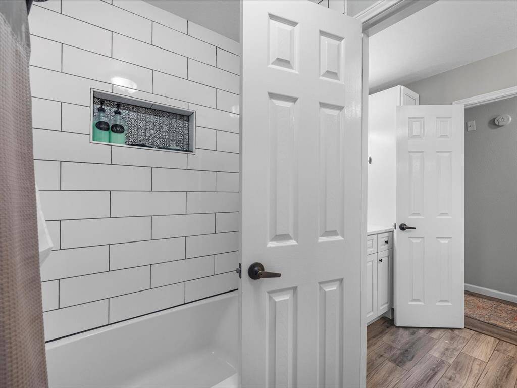 Looking back from the shower towards the sink area