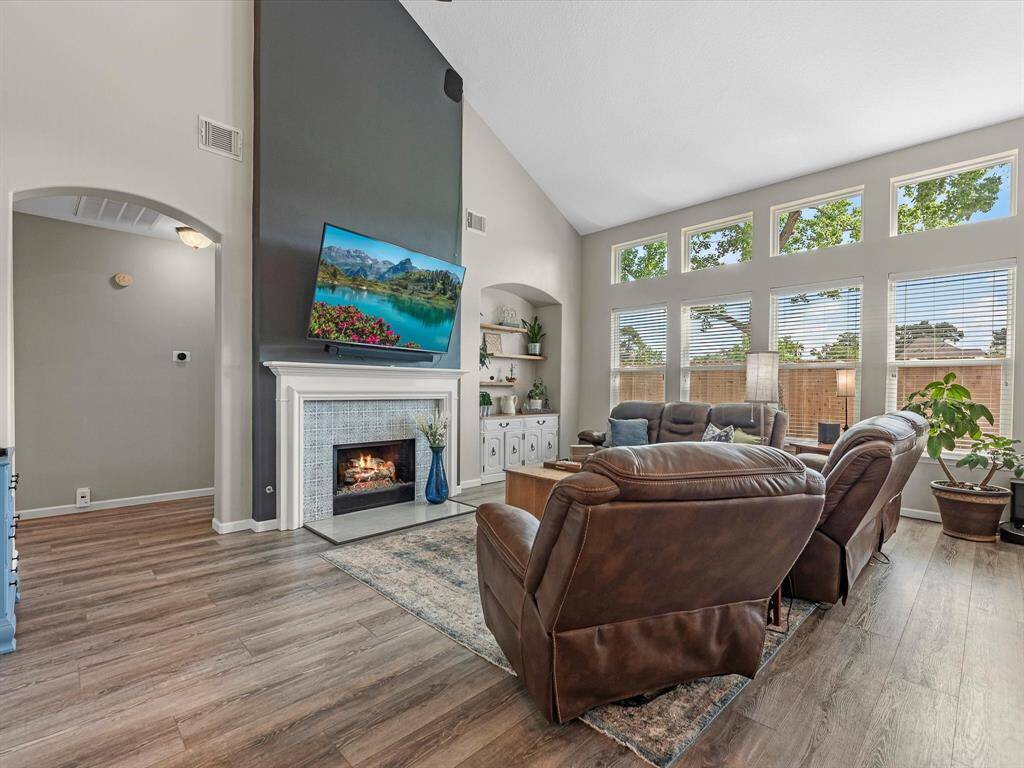 The family room continues the great high ceilings, solid flooring and gorgeous fireplace