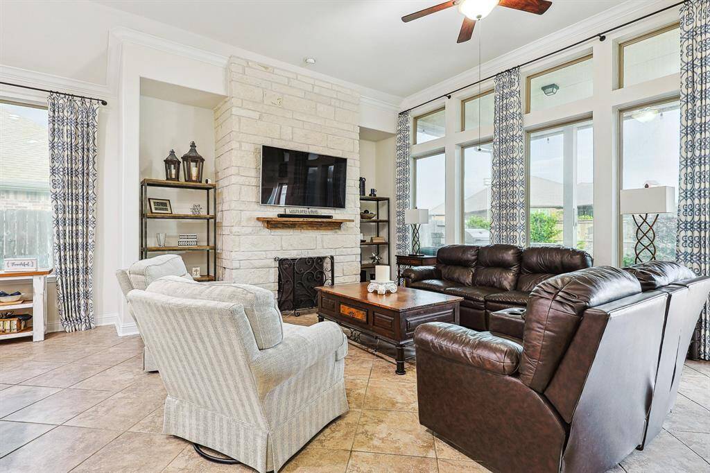 Living room with cozy fireplace and bright windows
