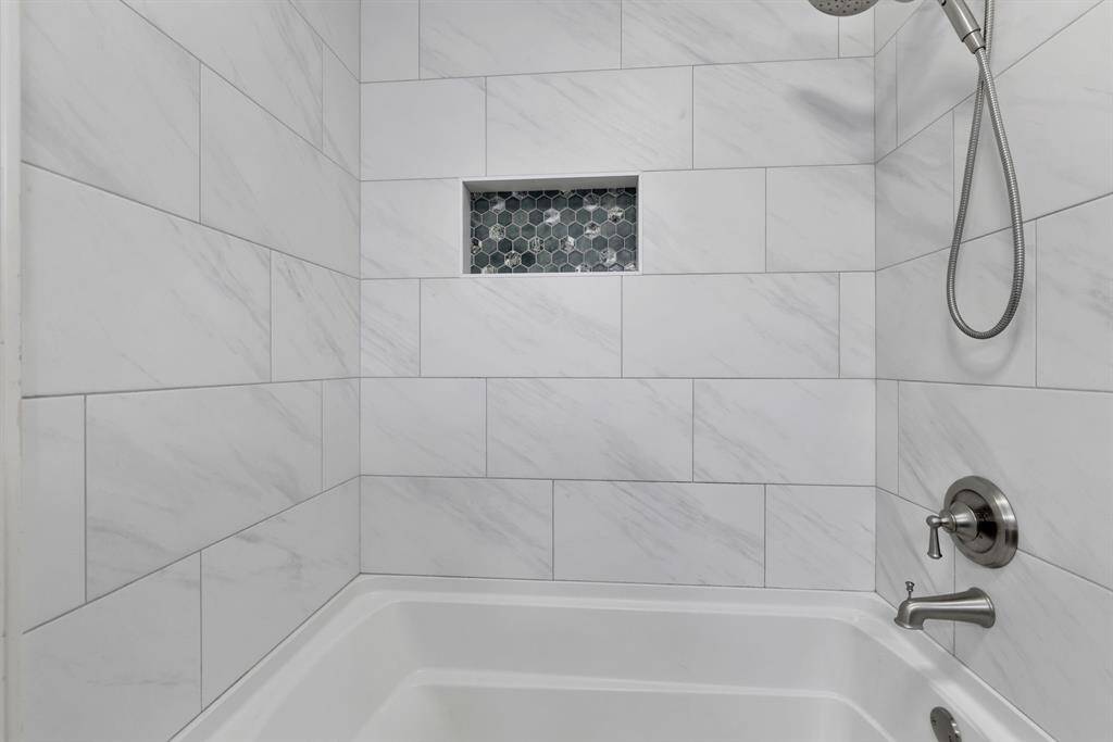 Secondary tub-shower combo is beautifully remodeled
