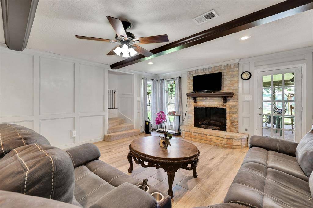 Wood beams adorn the ceilings in the living area