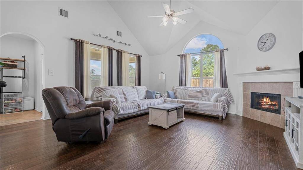 Spacious living room with soaring ceilings and walls of windows that flood the space with natural light.