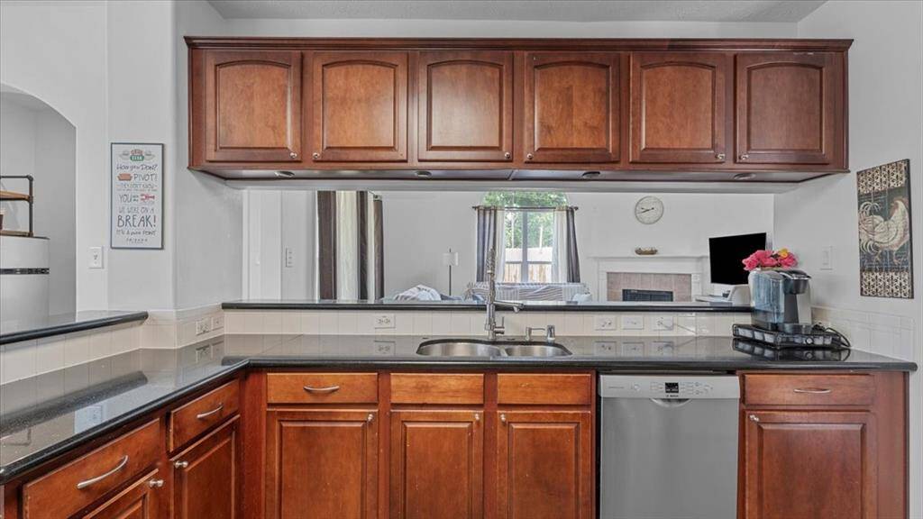 The kitchen’s breakfast bar opens to the living room, creating a seamless connection for entertaining.
