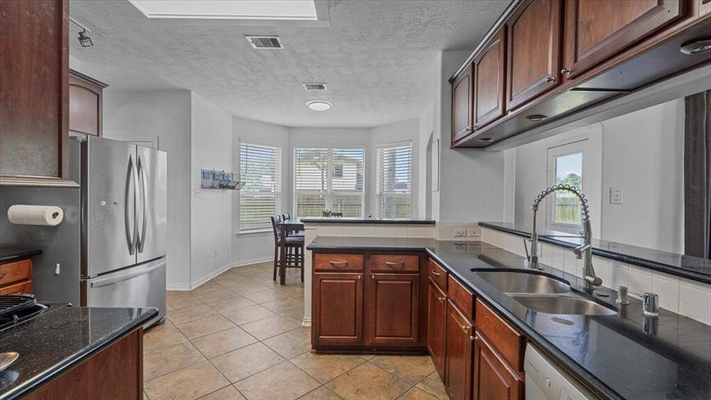 Stylish kitchen with granite counters, stainless steel appliances, and plenty of prep space