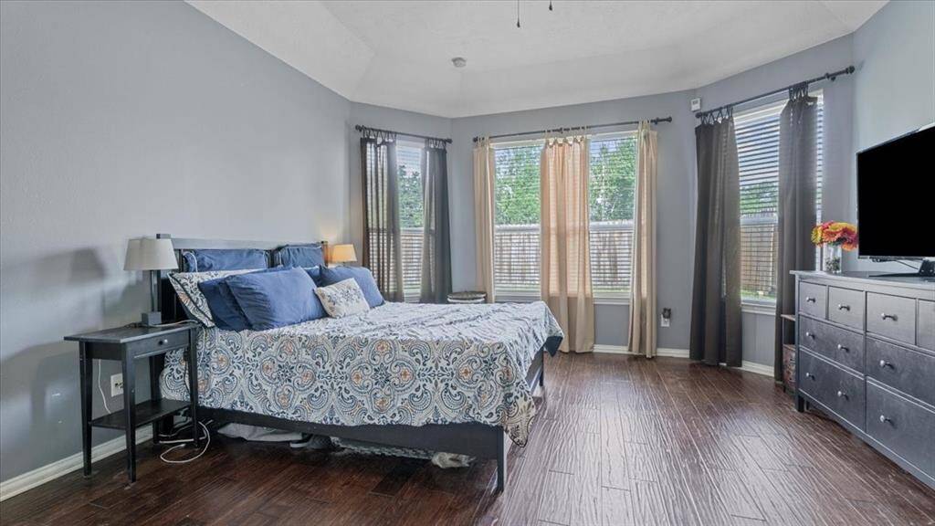 The primary bedroom is filled with natural light and offers direct access to the ensuite bath