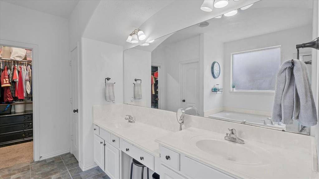 Spacious primary bathroom with dual vanities and ample storage